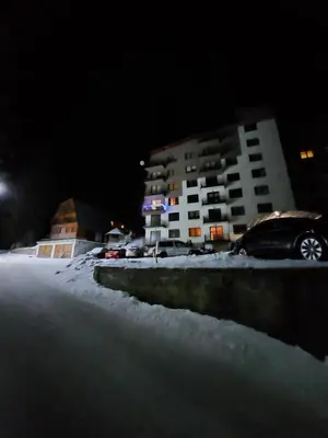 a car parked in a parking lot in the snow at Apartman Zlaja Vlašić in Vlasic