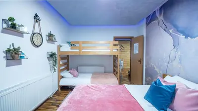 a bedroom with two beds and a bunk bed at Alpin Apartments Vlašić in Vlasic