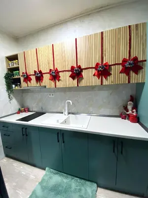 a kitchen with a sink and red bows on the wall at Alpin Apartments Vlašić in Vlasic