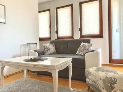 a living room with a couch and a coffee table at All White in Banja Luka