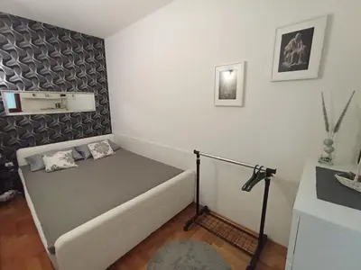 a small bedroom with a bed in a room at All White in Banja Luka