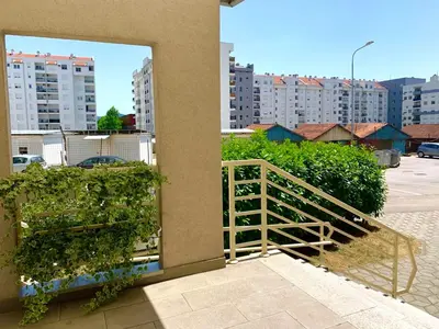 a view of a balcony with a fence and buildings at All White in Banja Luka