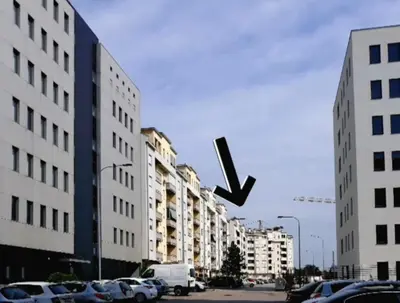 a x is flying over a city with buildings at All White in Banja Luka