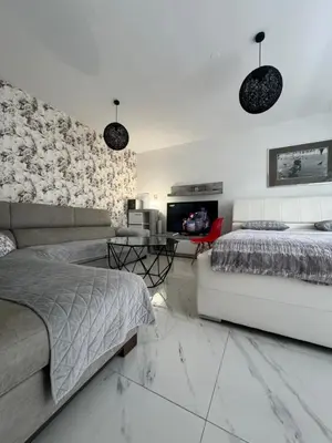 a living room with a bed and a couch at Apartman CITY CENTER 2 in Prijedor