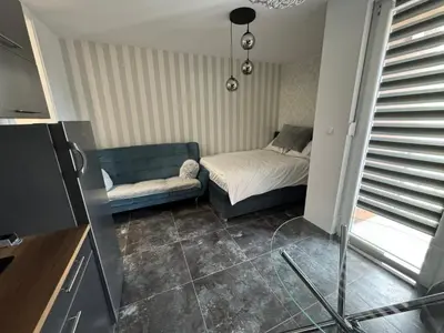 a living room with a couch and a bed at Apartman CITY CENTER 2 in Prijedor