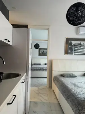 a kitchen with a sink and a bed in a room at Apartman CITY CENTER 2 in Prijedor