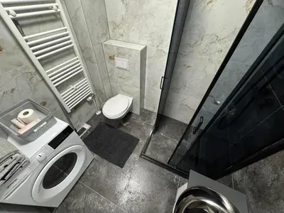 a bathroom with a shower and a toilet and a sink at Apartman CITY CENTER 2 in Prijedor