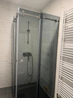 a shower with a glass door in a bathroom at Apartman CITY CENTER 2 in Prijedor