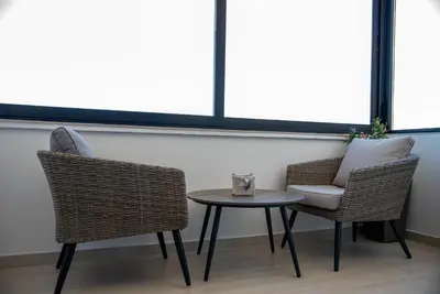 a table and two chairs and a table with a pillow at Apartman Ante in Livno