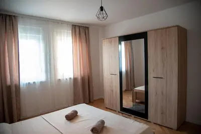 a bedroom with a large mirror and a bed at Apartman Ante in Livno