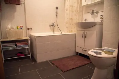 a bathroom with a tub and a sink and a toilet at Apartman Ante in Livno