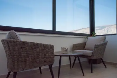 a room with a table and two chairs and a window at Apartman Ante in Livno