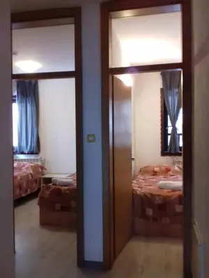 a room with two doors and a bed in it at City View Apartment in Fojnica