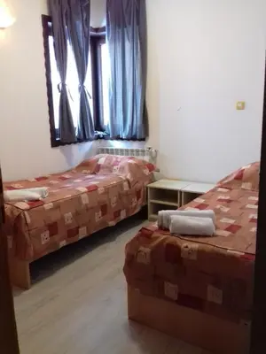 a bedroom with two beds and a window at City View Apartment in Fojnica