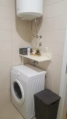 a white washer and dryer in a bathroom at Fantasy apartment Tuzla in Tuzla