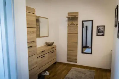 a room with a dresser and a mirror at Fantasy apartment Tuzla in Tuzla