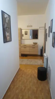 a hallway with a room with a dresser in a room at Fantasy apartment Tuzla in Tuzla