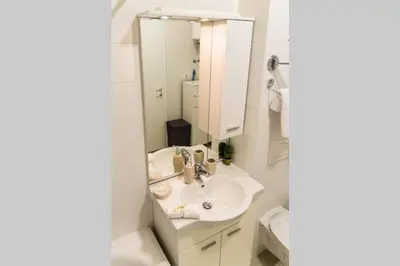 a bathroom with a sink and a mirror at Fantasy apartment Tuzla in Tuzla