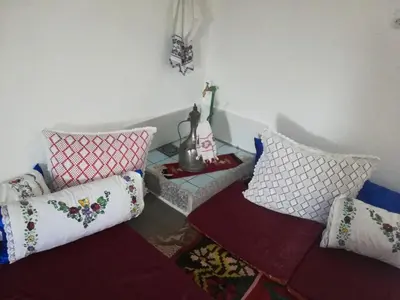 a group of pillows in a room with a table at Apartman Bosanska Avlija-Muzej- in Visoko