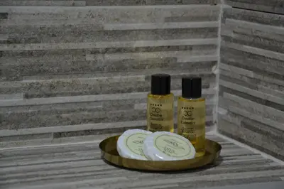 two bottles ofodorizers sitting on a tray next to a wall at ATOS Centar in Čelinac