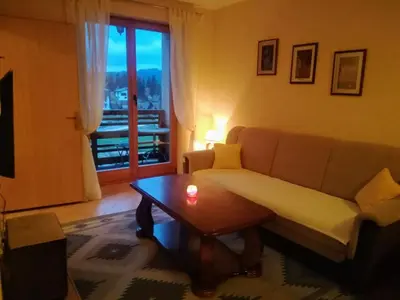 a living room with a couch and a coffee table at Apartman SARA Babanovac Vlašić in Travnik