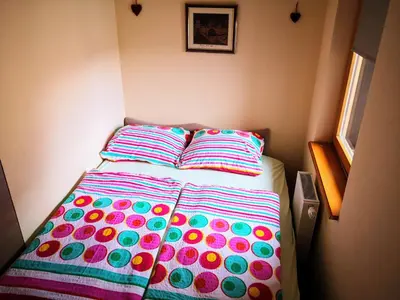 a bed in a room with two pillows on it at Apartman SARA Babanovac Vlašić in Travnik