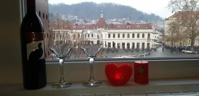 a window with two wine glasses and a heart on a window sill at Apartman Amor in Tuzla