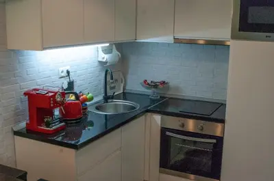 a kitchen with a sink and a mixer on a counter at Apartman Amor in Tuzla