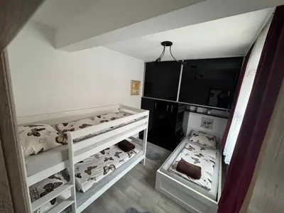 a room with two bunk beds with animals on them at Apartman 