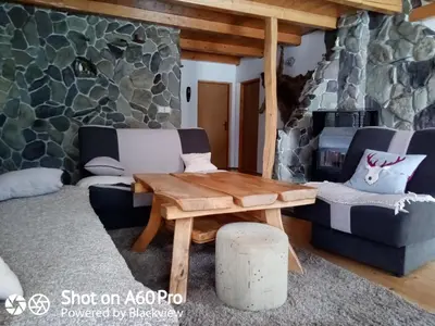 a living room with a couch and a table at kuća za odmor Katy in Kupres