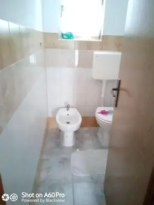 a bathroom with a toilet and a sink at kuća za odmor Katy in Kupres