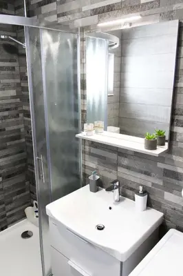 a bathroom with a white sink and a shower at Kuća za odmor ANA in Kupres