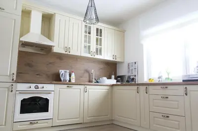 a kitchen with white cabinets and a sink at Kuća za odmor ANA in Kupres