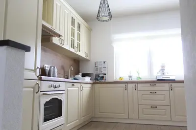 a kitchen with white cabinets and a window at Kuća za odmor ANA in Kupres
