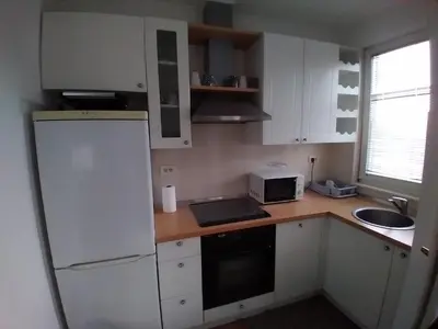 a kitchen with white cabinets and a white refrigerator at Apartman CENTAR in Banja Luka