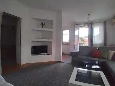 a living room with a couch and a fireplace at Apartman CENTAR in Banja Luka