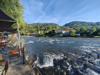 a boat is traveling down a river at Apartman CENTAR in Banja Luka