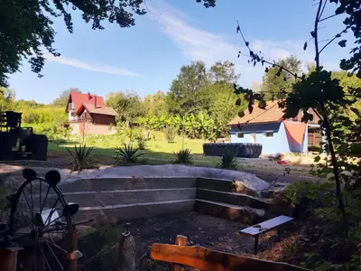 a garden with stairs and a house in the background at Log Cabins Jovicic in Bosanska Dubica