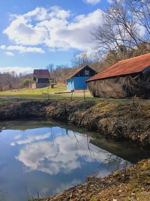 a reflection of the sky in a body of water at Log Cabins Jovicic in Bosanska Dubica
