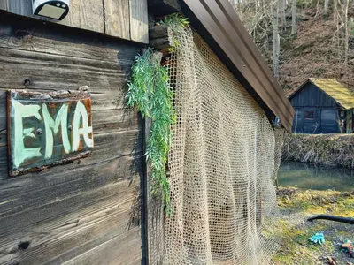 a building with a m sign on the side of it at Log Cabins Jovicic in Bosanska Dubica