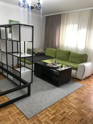 a living room with a couch and a table at Dan i noc in Banja Luka