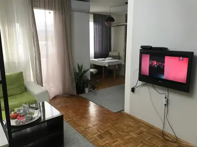 a living room with a flat screen tv on a wall at Dan i noc in Banja Luka