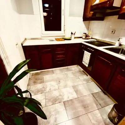 a kitchen with a sink and a stove top oven at Dan i noc in Banja Luka