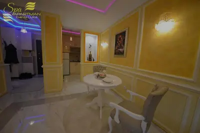 a dining room with a table and chairs in a room at Spa Apartman Banja Luka in Banja Luka