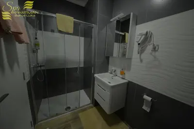 a bathroom with a shower and a toilet and a sink at Spa Apartman Banja Luka in Banja Luka