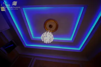 a room with a blue ceiling with a chandelier at Spa Apartman Banja Luka in Banja Luka