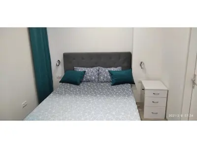 a small bedroom with a bed with blue pillows at Slatka Tajna in Banja Luka