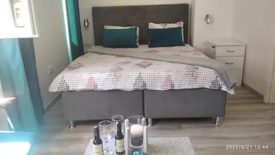 a bedroom with a large bed with green pillows at Slatka Tajna in Banja Luka