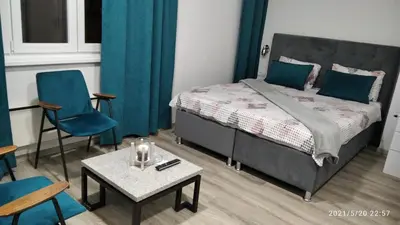 a bedroom with a bed and a table and chairs at Slatka Tajna in Banja Luka