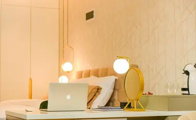 a bedroom with a bed and a laptop on a table at Hotel City View in Prnjavor